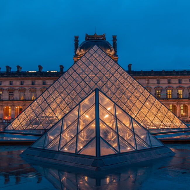 Amazing view from a Louvre Pyramid from a dark and moody day with rainy weather.